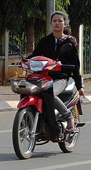 A Girl on a Motorbike in Pakse by Asienreisender